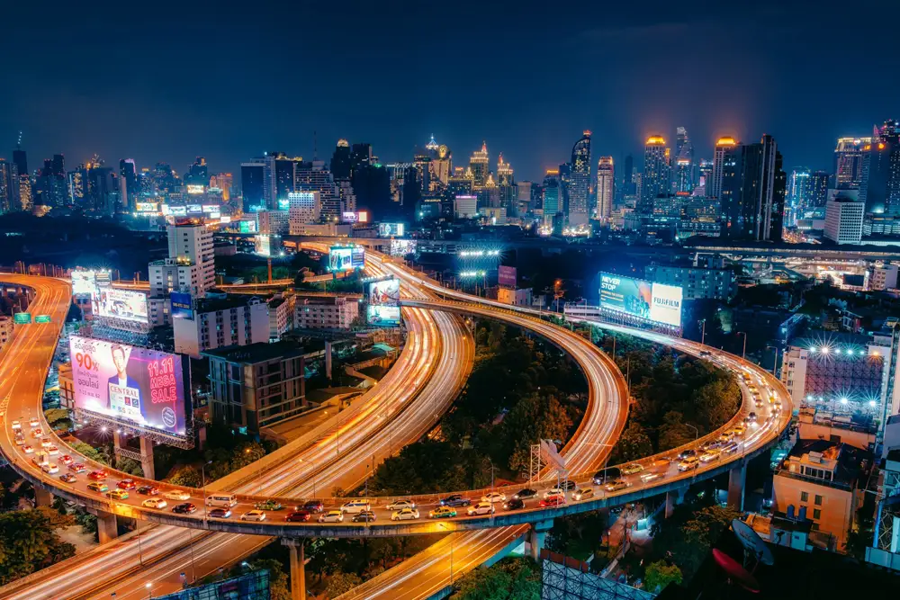 bangkok expressway interchange at night with traffic light trails