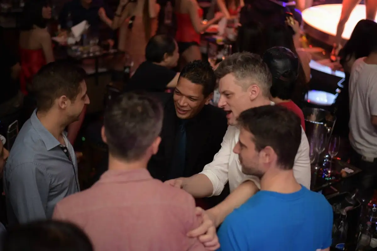 Group of friends enjoying VIP nightlife and bottle service at a Bangkok nightclub