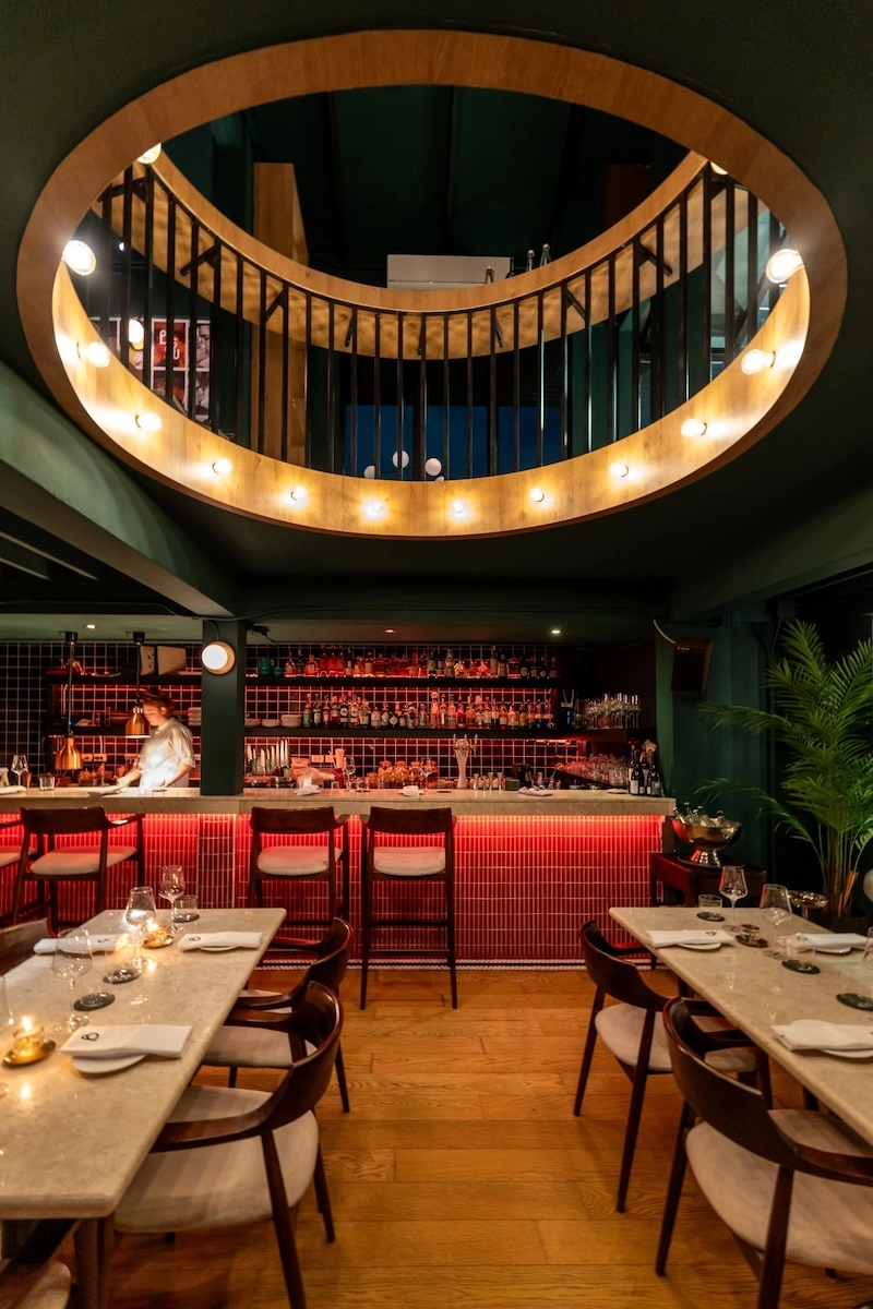 interior of french restaurant Bisou Bangkok in Lang Suan with dim lights and intimate setting