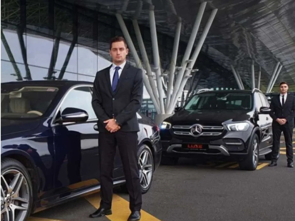 professional security team positioned beside executive vehicles in bangkok