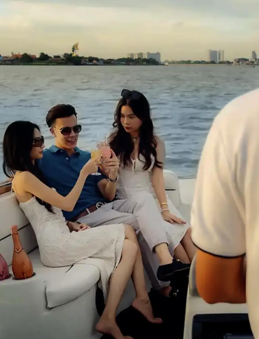 sunset cruise on chopraya river with a group of three person enjoying champagne