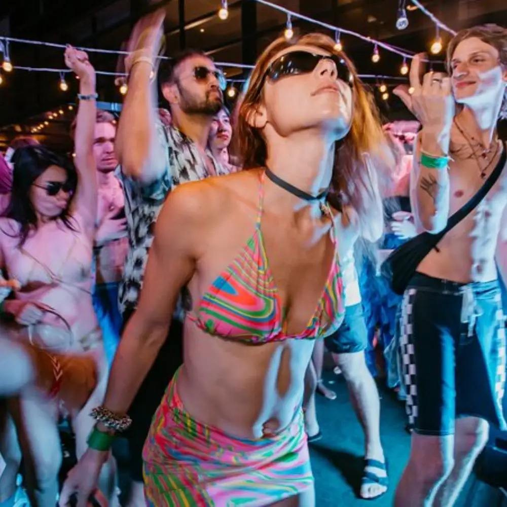 white girl enjoying the vibe with glasses at an outdoor event in bangkok